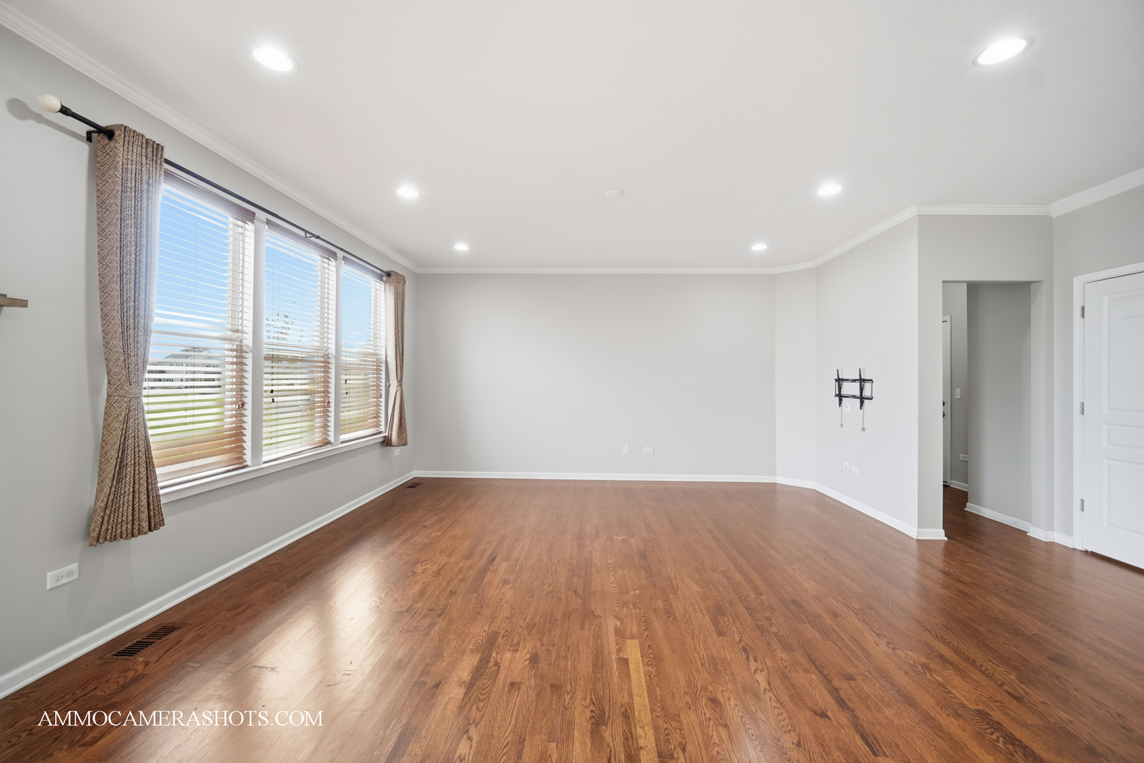 4308 Fraser Circle Naperville, IL 60564 - Photo 14 of 43 a view of an empty room with wooden floor and a window