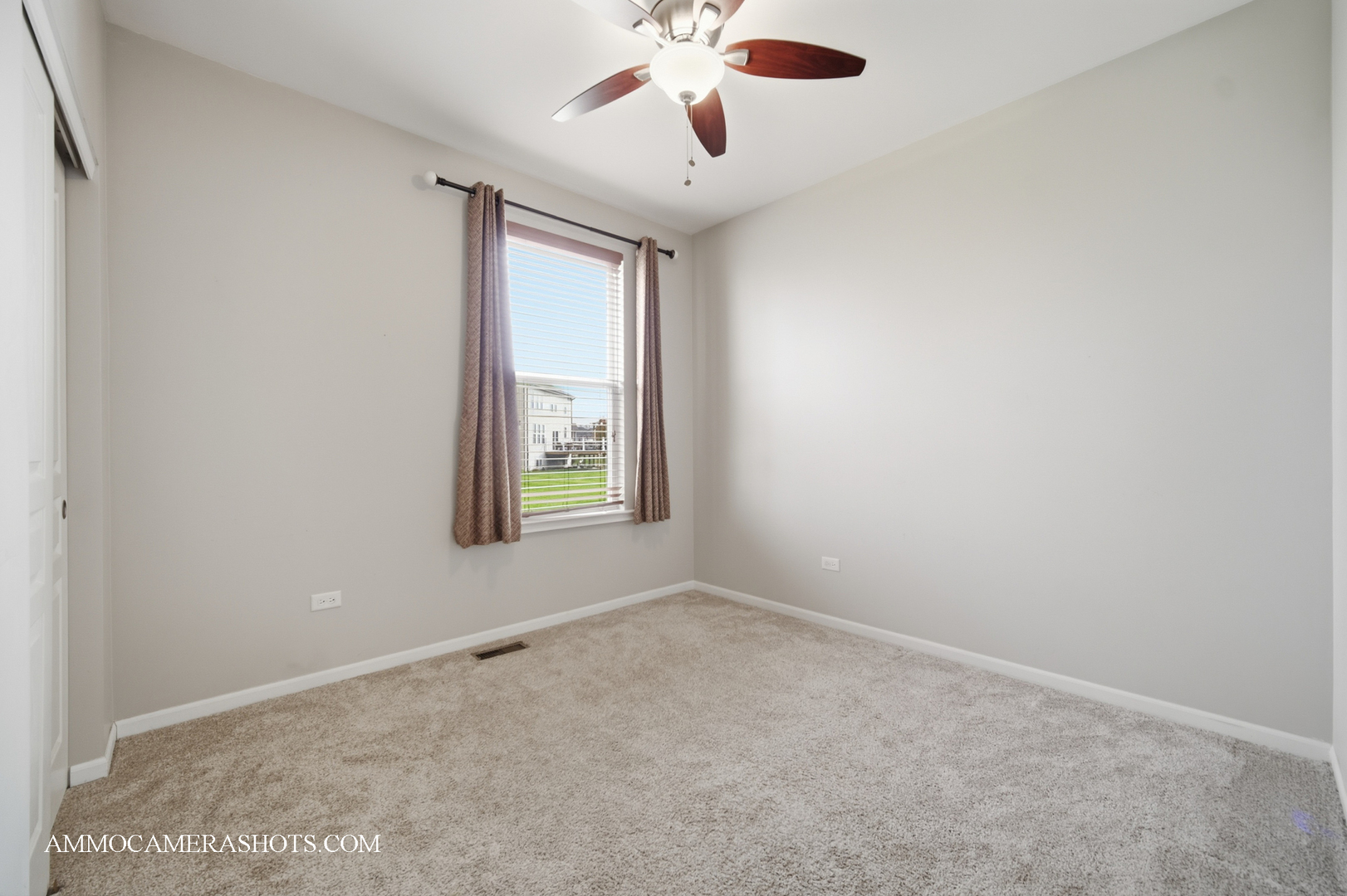 4308 Fraser Circle Naperville, IL 60564 - Photo 4 of 43 an empty room with windows and chandelier fan