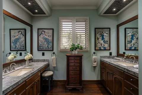 a spacious bathroom with a granite countertop sink a large mirror and a window