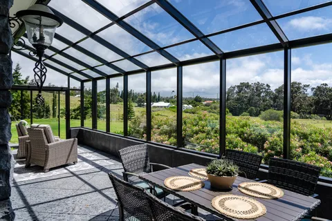 a living room with furniture and a floor to ceiling window