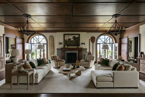 a living room with furniture a fireplace and a chandelier