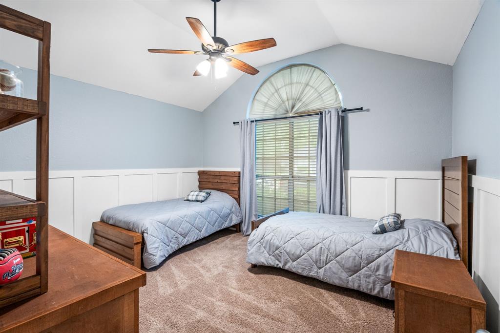 2302 Randi Road Rowlett, TX 75088 - Photo 22 of 33 a bedroom with two beds and a chandelier