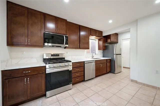 a kitchen with a sink cabinets and window