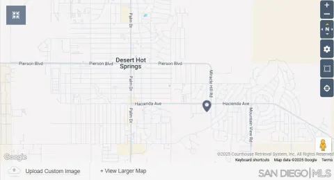 a front view of a house with a garden and lake view