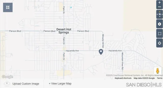 a front view of a house with a garden and lake view