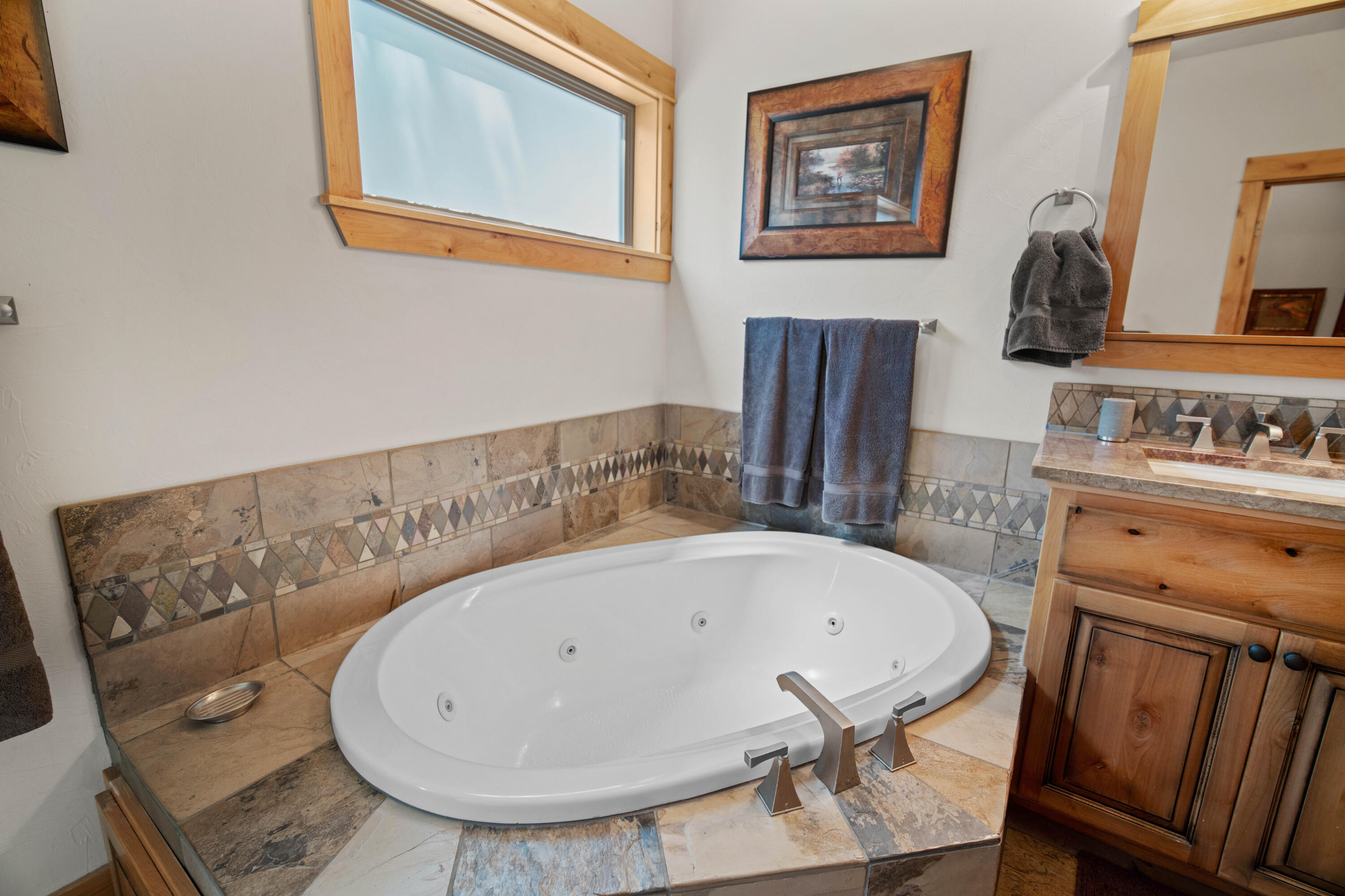 56689 Dancing Rock Loop Bend, OR 97707 - Photo 24 of 51 a bathroom with a bathtub and a sink