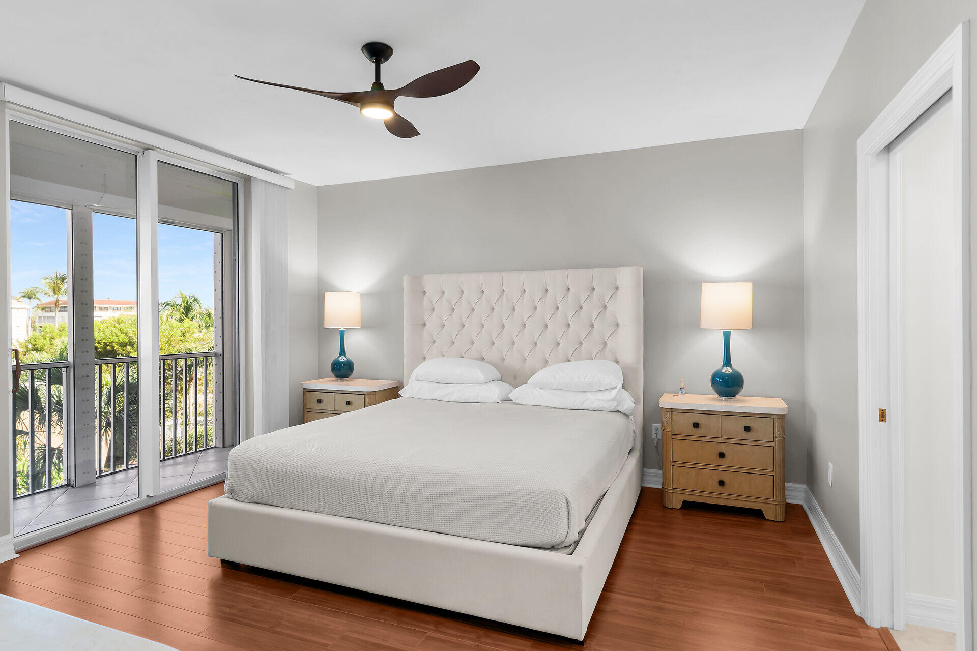 1111 Swallow Avenue, Unit 1401 Marco Island, FL 34145 - Photo 23 of 36 a bedroom with a bed and a chandelier