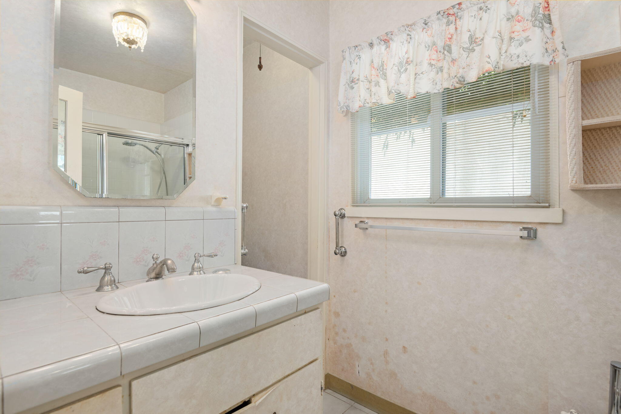 1712 Lasuen Road Santa Barbara, CA 93103 - Photo 12 of 36 a bathroom with a sink and a mirror