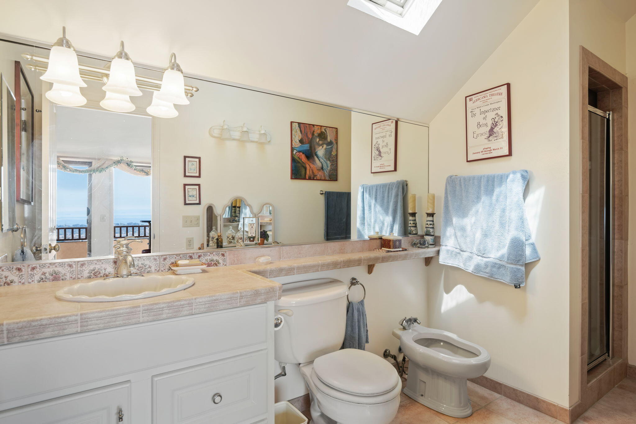 1712 Lasuen Road Santa Barbara, CA 93103 - Photo 18 of 36 a bathroom with a sink a toilet and a large mirror