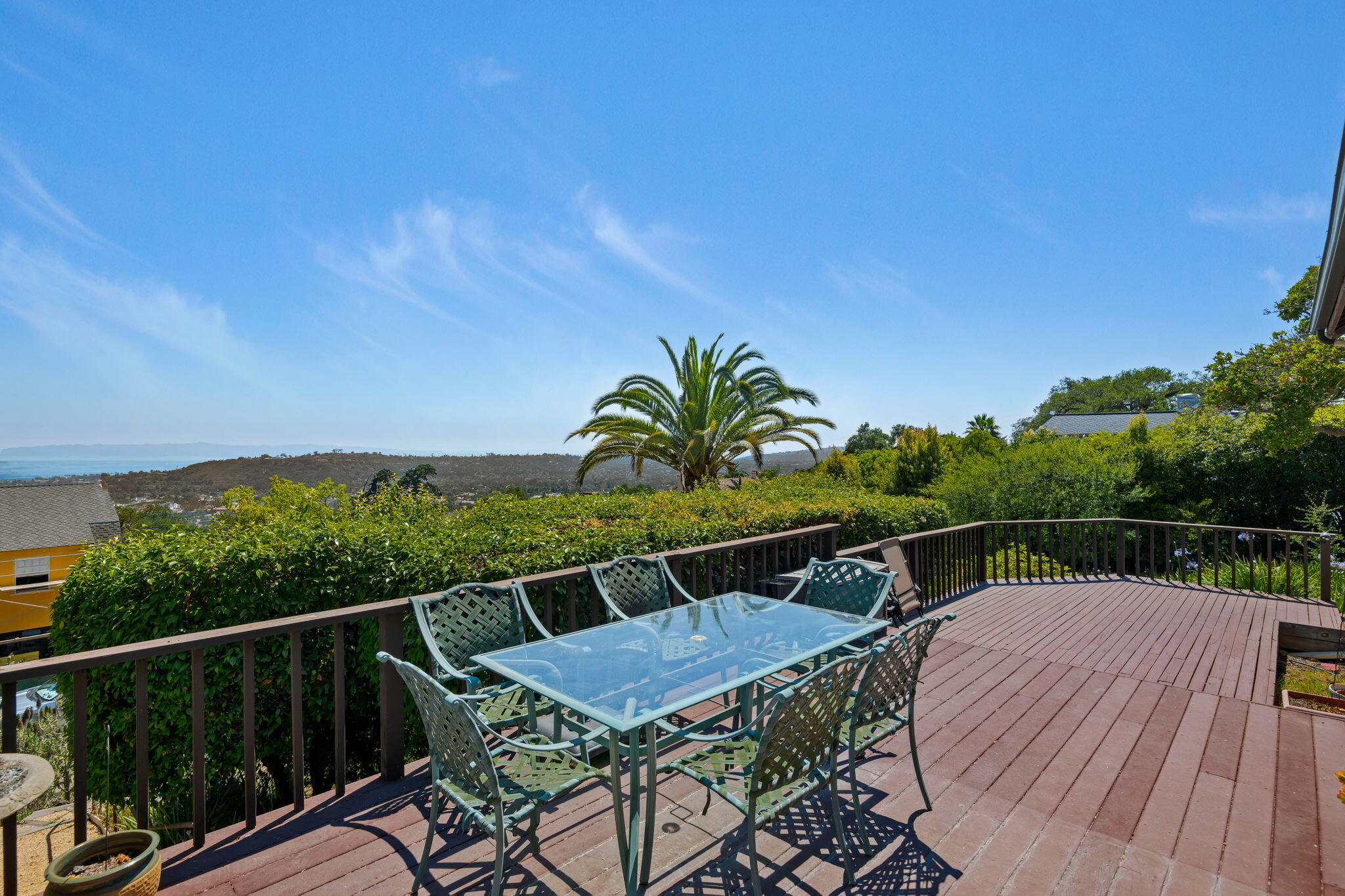 1712 Lasuen Road Santa Barbara, CA 93103 - Photo 5 of 36 a balcony with wooden floor table and chairs