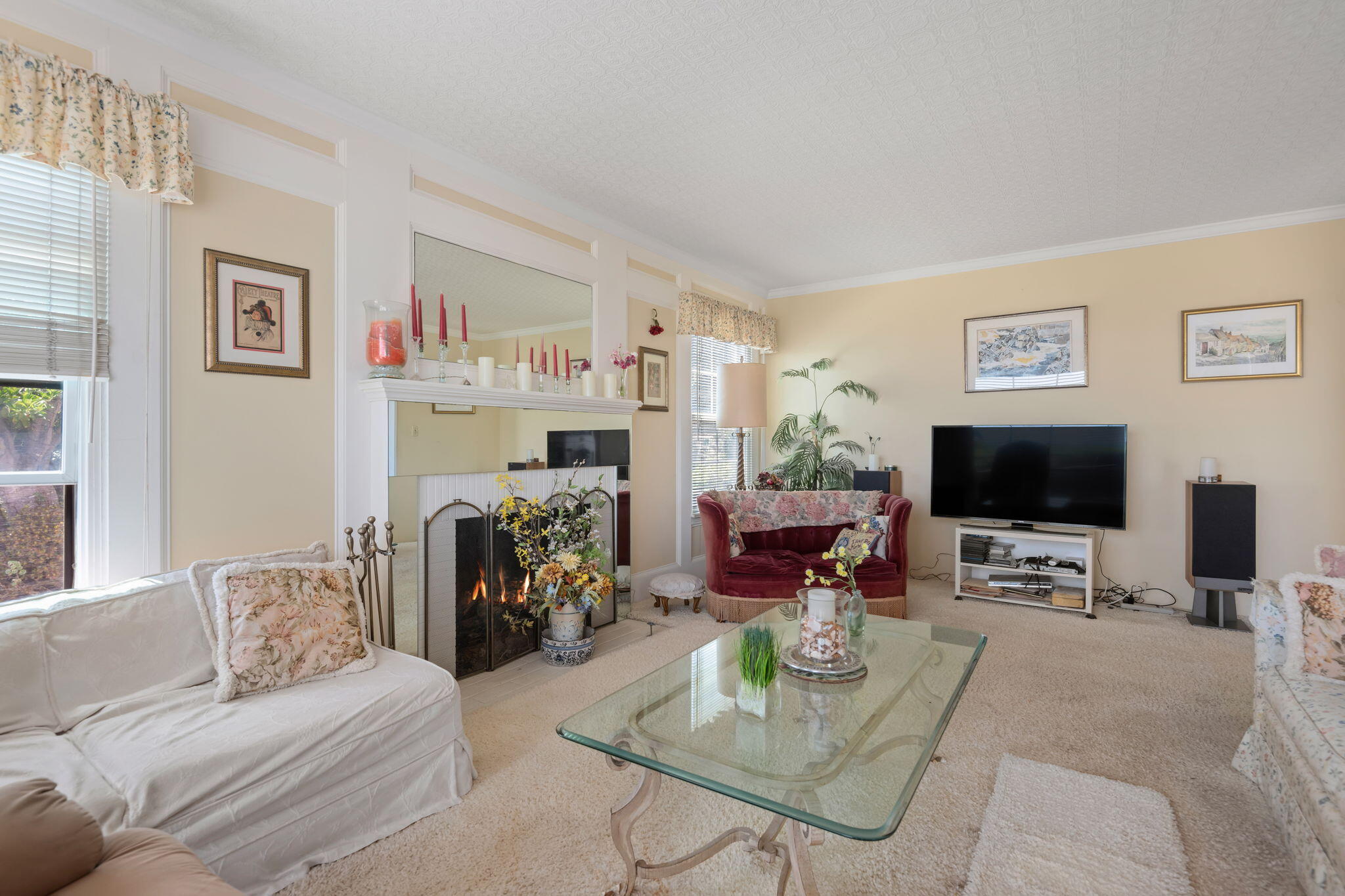 1712 Lasuen Road Santa Barbara, CA 93103 - Photo 7 of 36 a living room with furniture a fireplace and a flat screen tv
