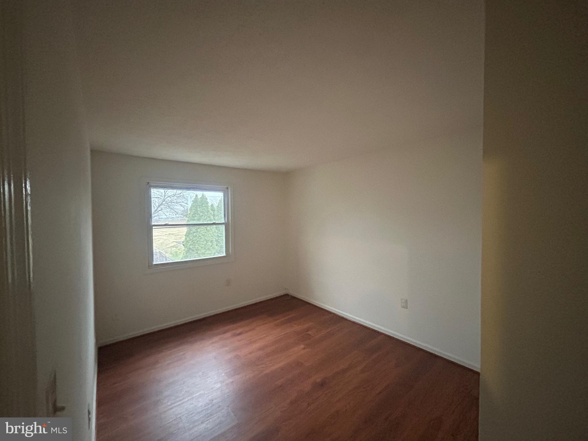 10177 Irongate Way Manassas, VA 20109 - Photo 12 of 25 an empty room with wooden floor and windows