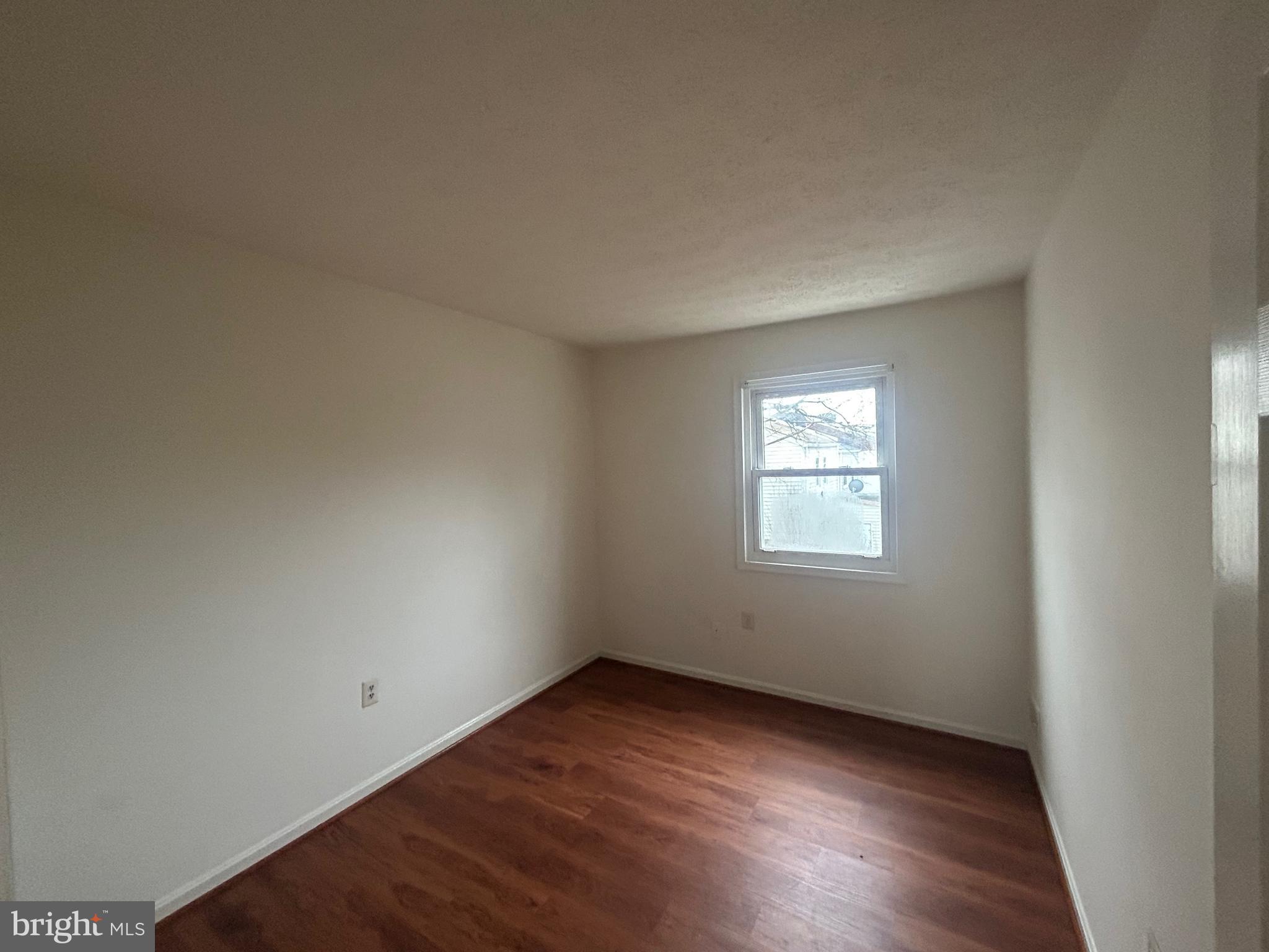 10177 Irongate Way Manassas, VA 20109 - Photo 14 of 25 an empty room with wooden floor and windows