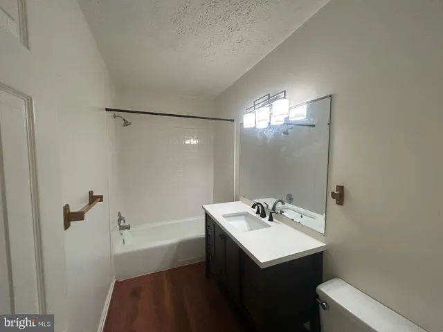 a bathroom with a sink a toilet a shower and a mirror