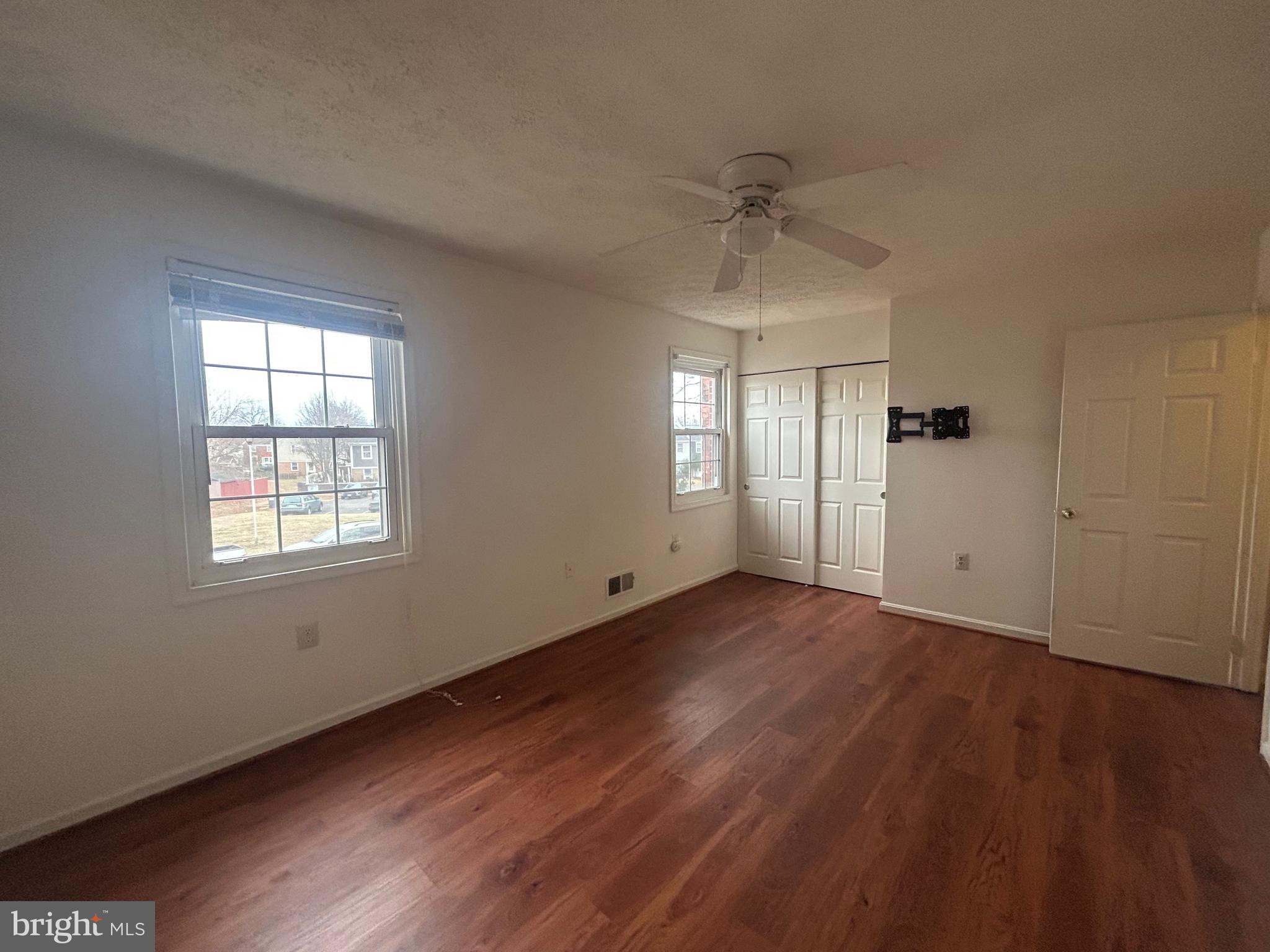 10177 Irongate Way Manassas, VA 20109 - Photo 18 of 25 a view of an empty room with wooden floor and a window