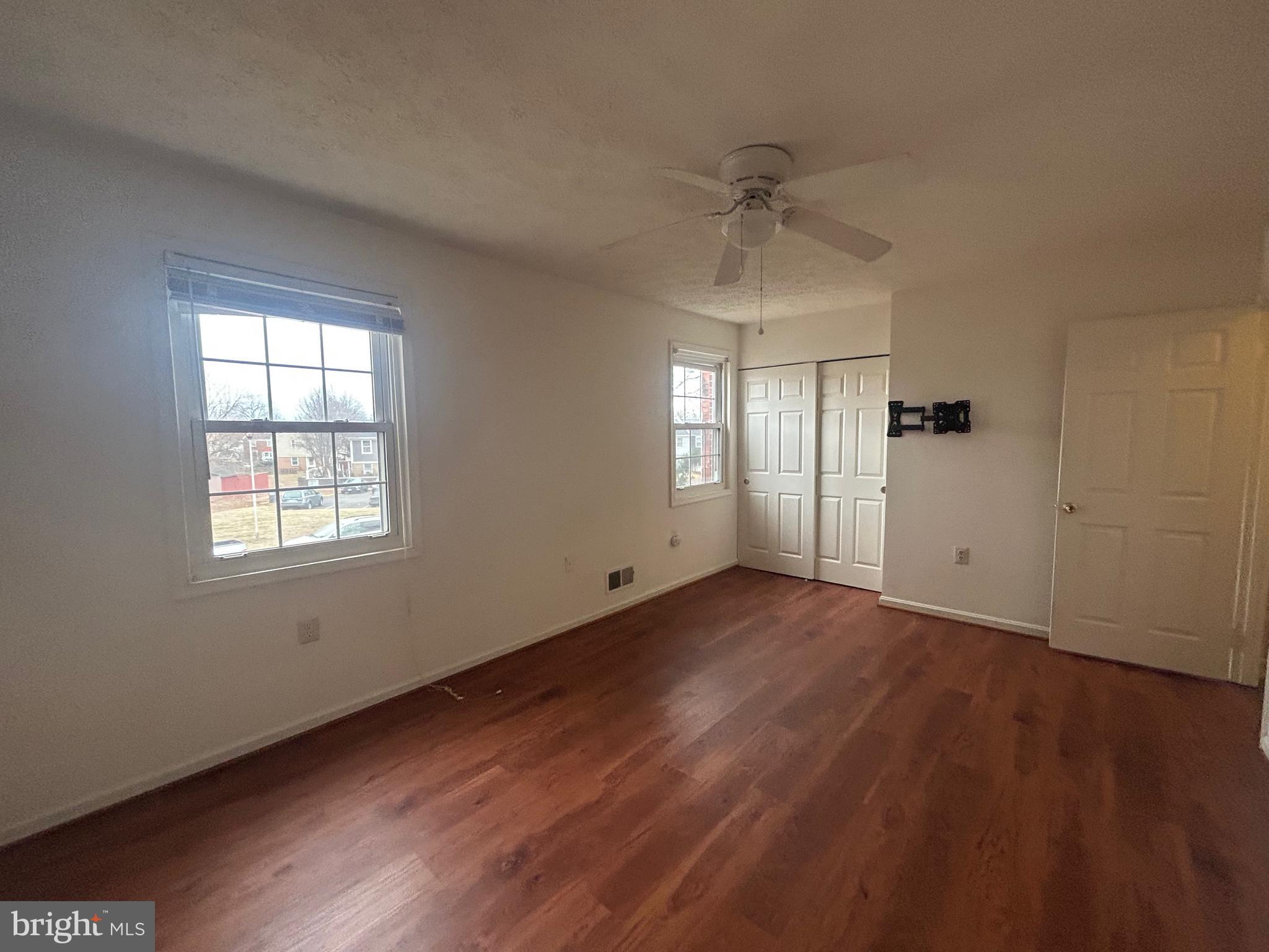 10177 Irongate Way Manassas, VA 20109 - Photo 19 of 25 a view of an empty room with wooden floor and a window