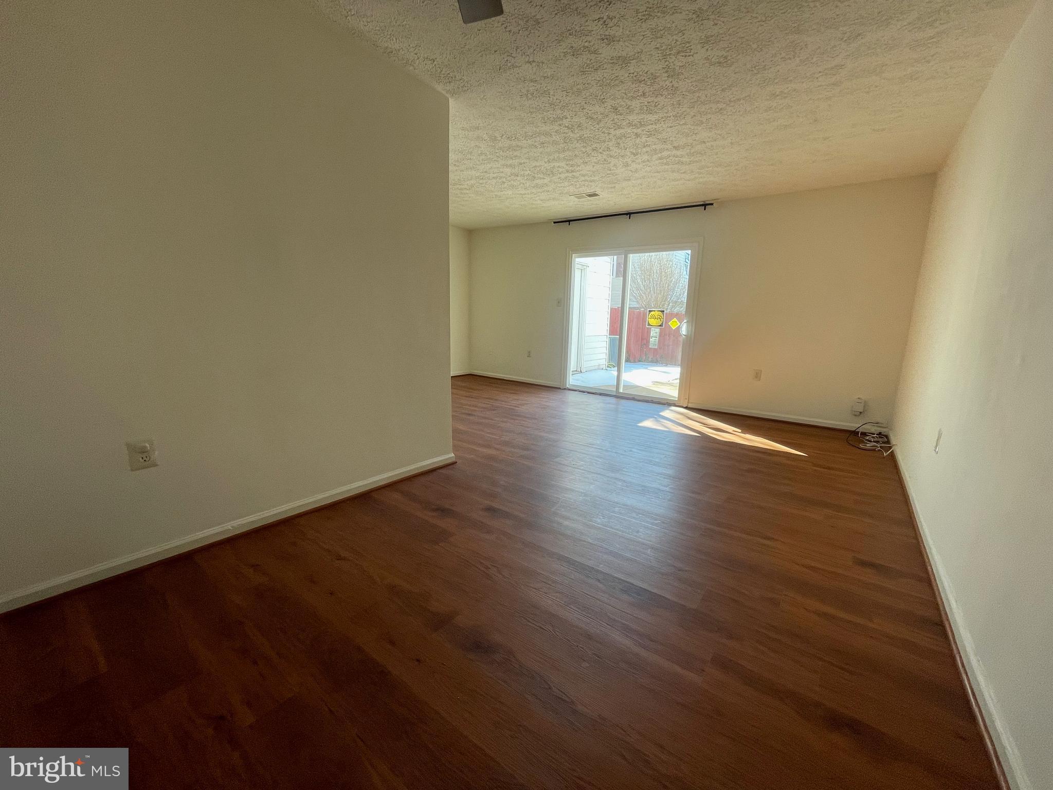 10177 Irongate Way Manassas, VA 20109 - Photo 23 of 25 an empty room with wooden floor and windows