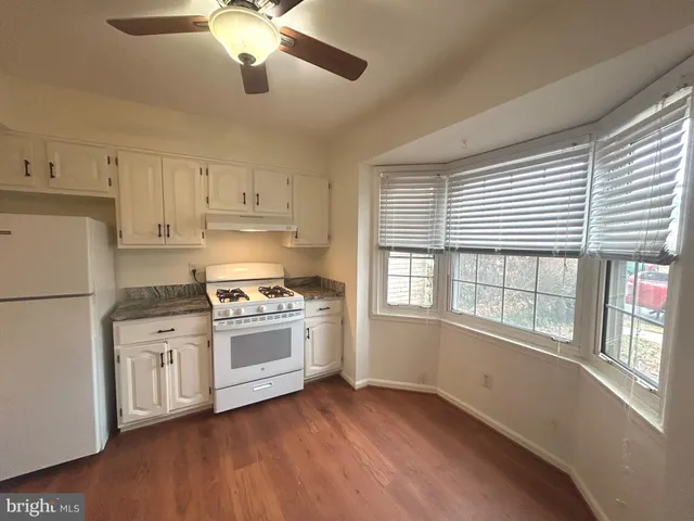 a kitchen with stove and cabinets