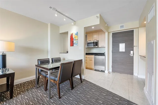 a bedroom with two beds and a flat screen tv