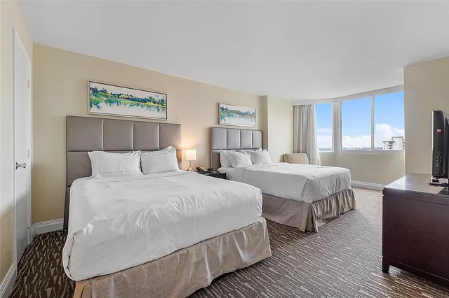 a bedroom with double bed and a window