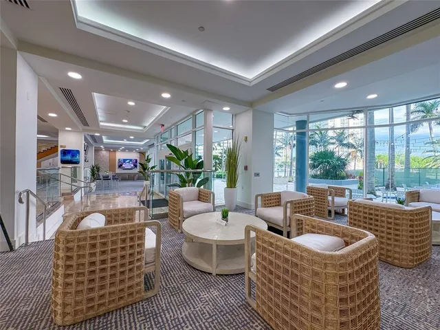 a view of the patio with dining table and chairs under an umbrella