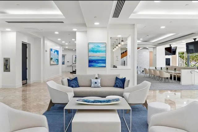 a view of a patio with a table and chairs and potted plants