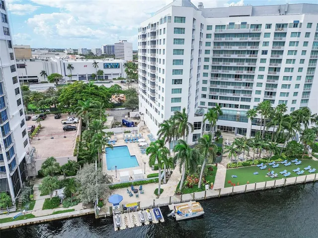 a kitchen with stainless steel appliances granite countertop a stove top oven a sink a dining table and chairs