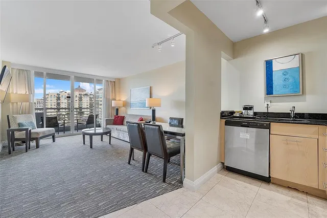 a living room with furniture a rug and a flat screen tv
