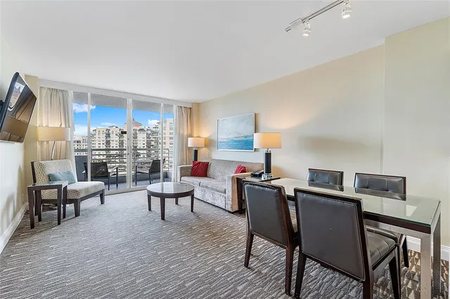 a view of a dining room with furniture and wooden floor