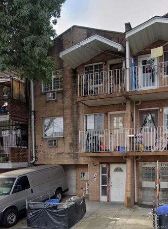 a front view of a house with barbeque and trees