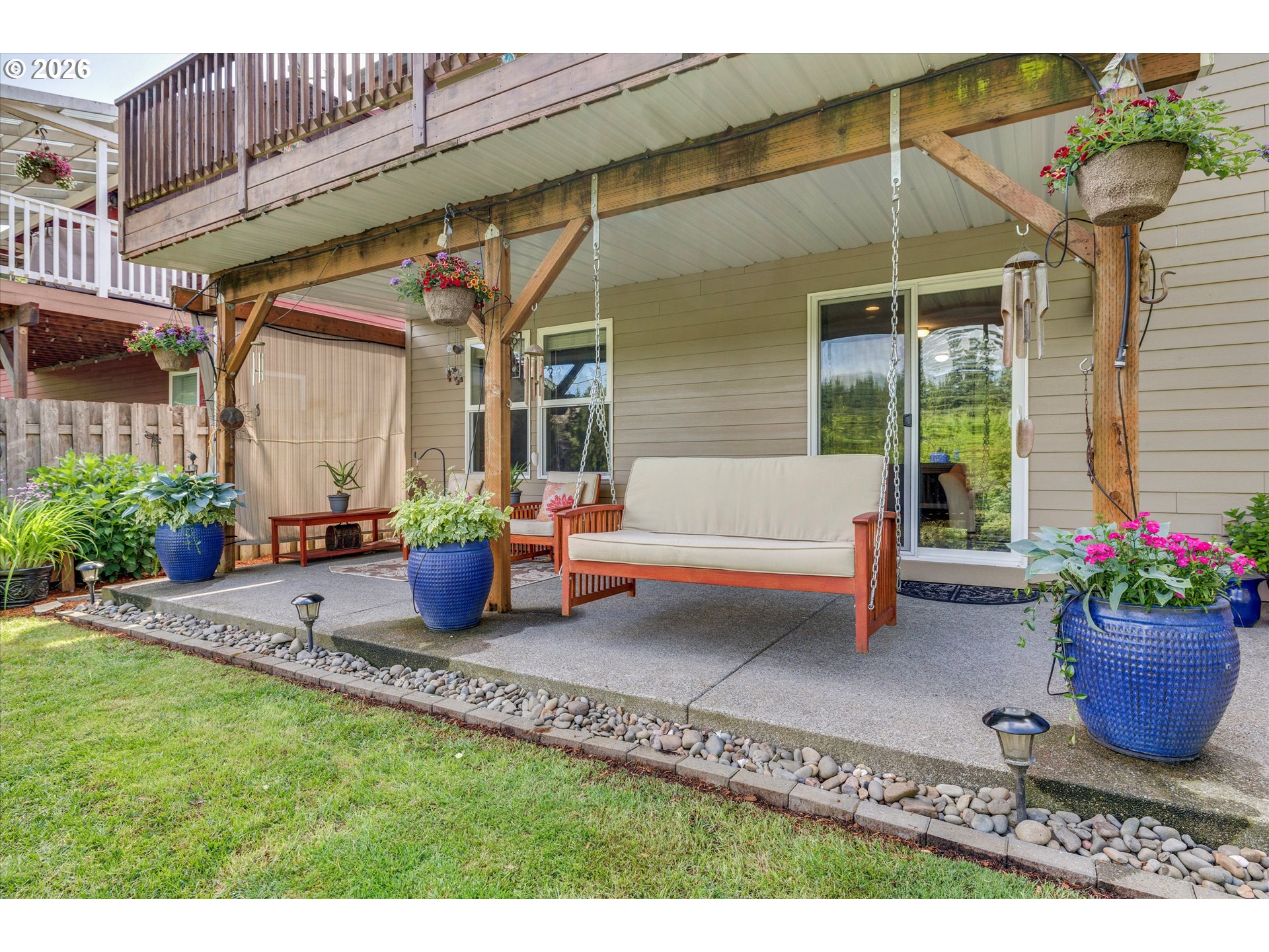 3769 10th Street Hubbard, OR 97032 - Photo 36 of 47 a view of a patio with a table and chairs and potted plants