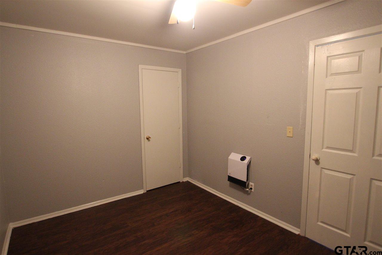 4229 Old Chandler Road, Unit B Tyler, TX 75702 - Photo 1 of 17 an empty room with wooden floor and closet