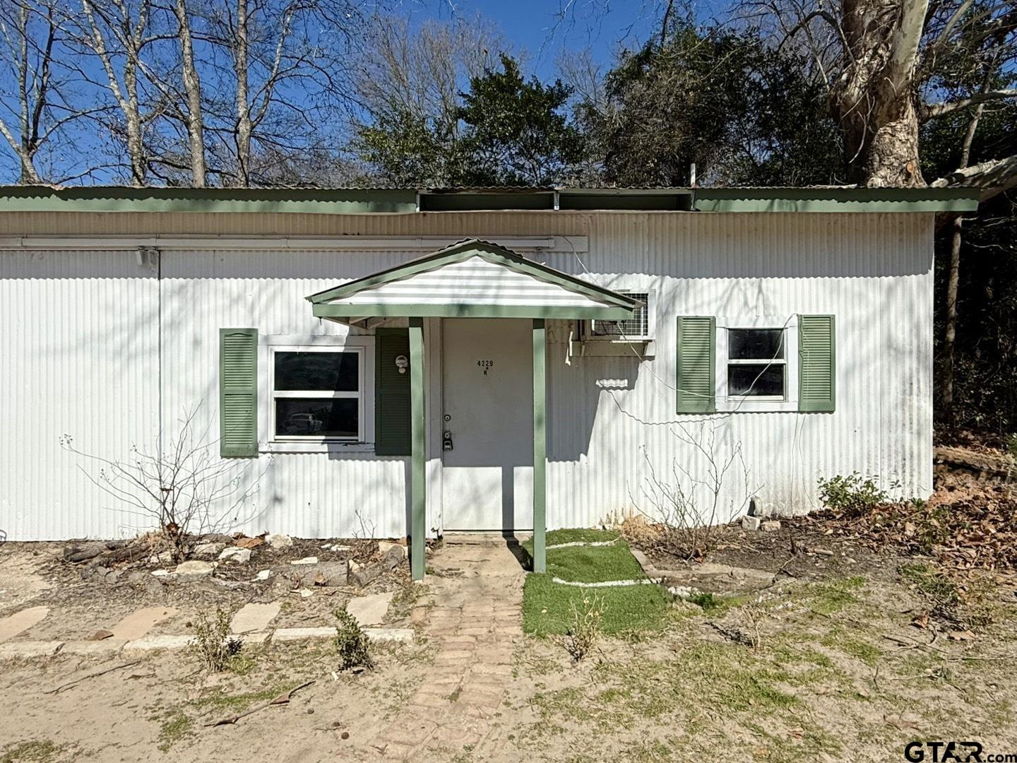 4229 Old Chandler Road, Unit B Tyler, TX 75702 - Photo 14 of 17 a house with trees in the background