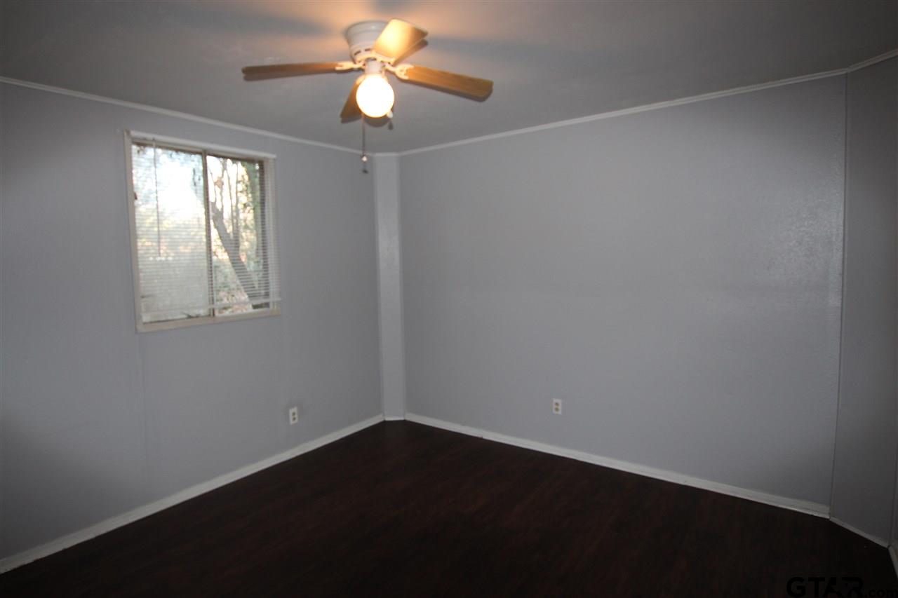 4229 Old Chandler Road, Unit B Tyler, TX 75702 - Photo 5 of 17 an empty room with windows and fan