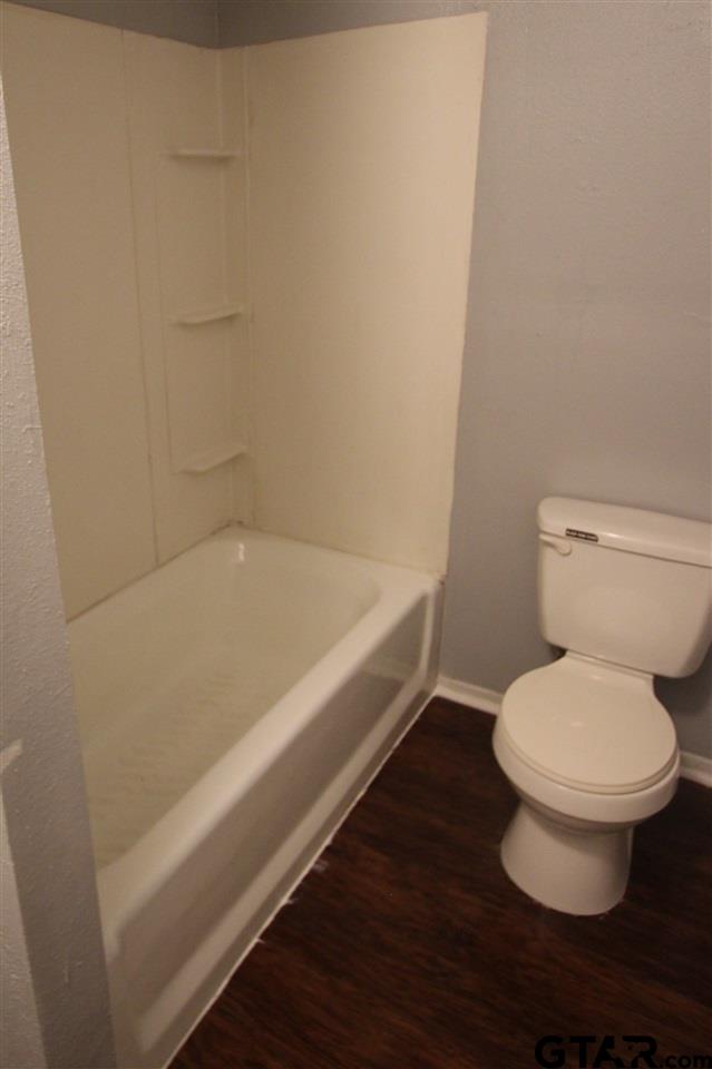 4229 Old Chandler Road, Unit B Tyler, TX 75702 - Photo 10 of 17 a bathroom with a toilet and a bathtub