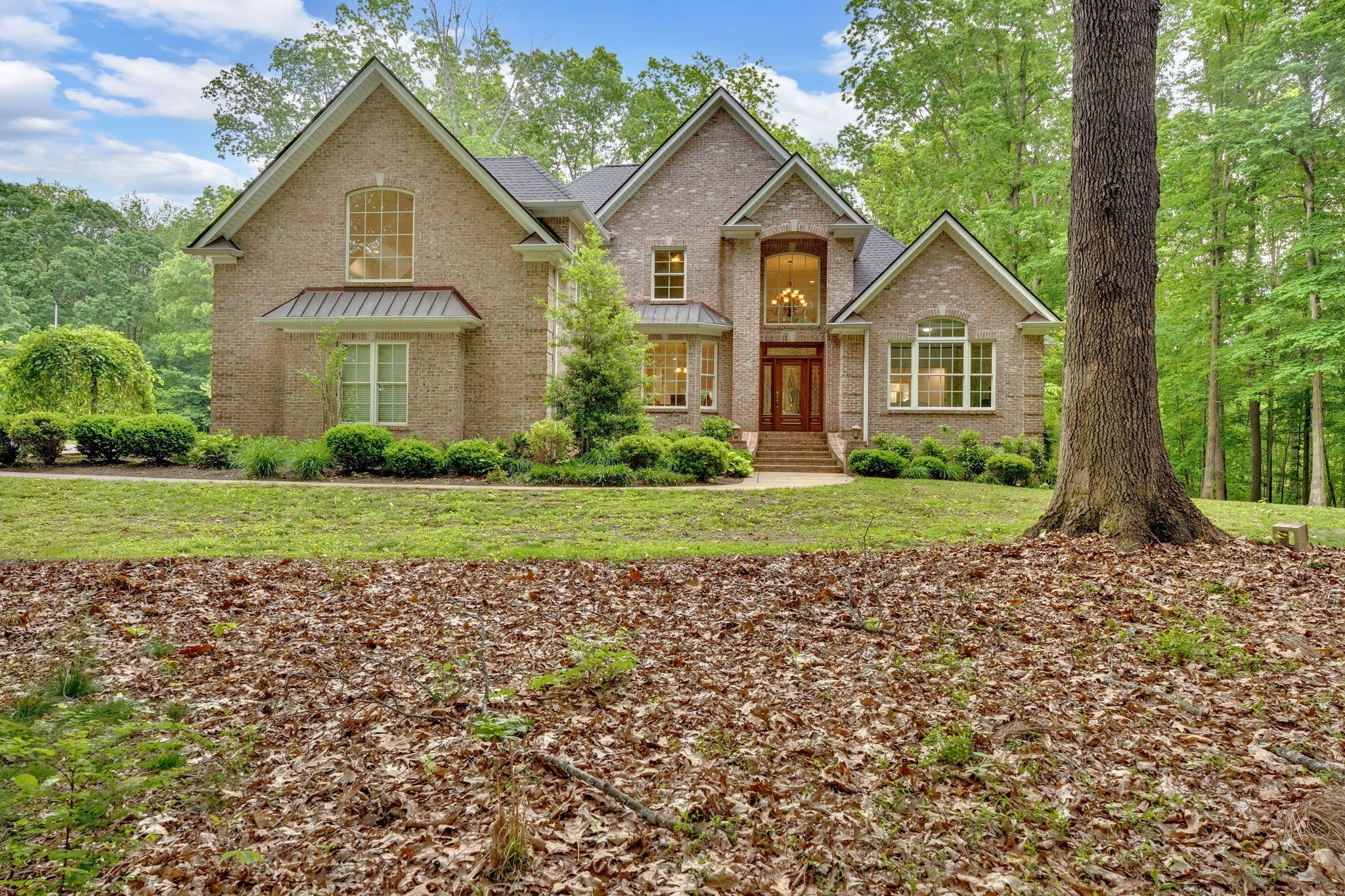 6948 Whispering Oaks Drive Springfield, TN 37172 - Photo 1 of 16 a front view of a house with a yard and garage