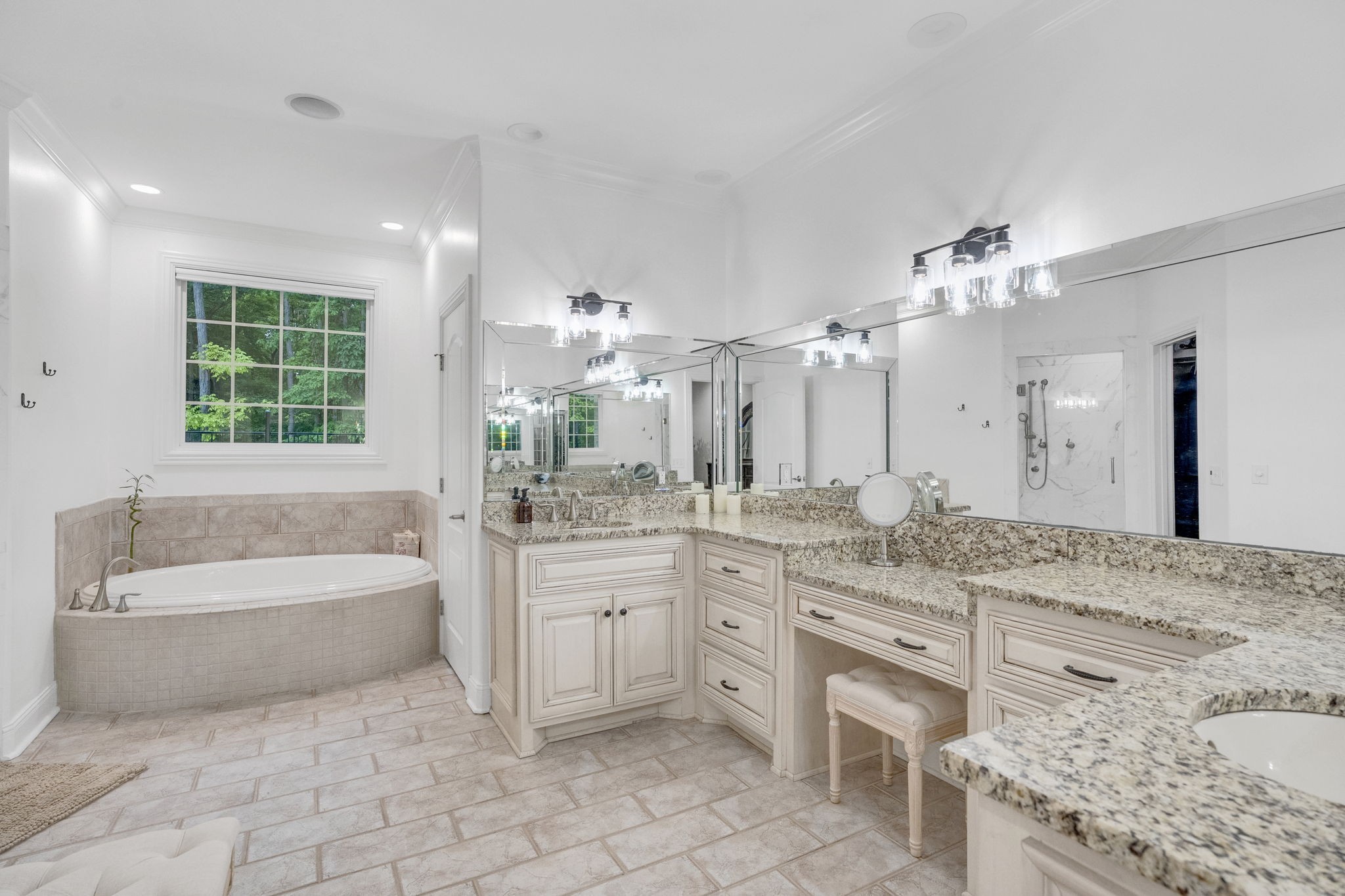 6948 Whispering Oaks Drive Springfield, TN 37172 - Photo 12 of 16 a spacious bathroom with a granite countertop sink a large mirror a bathtub and a shower