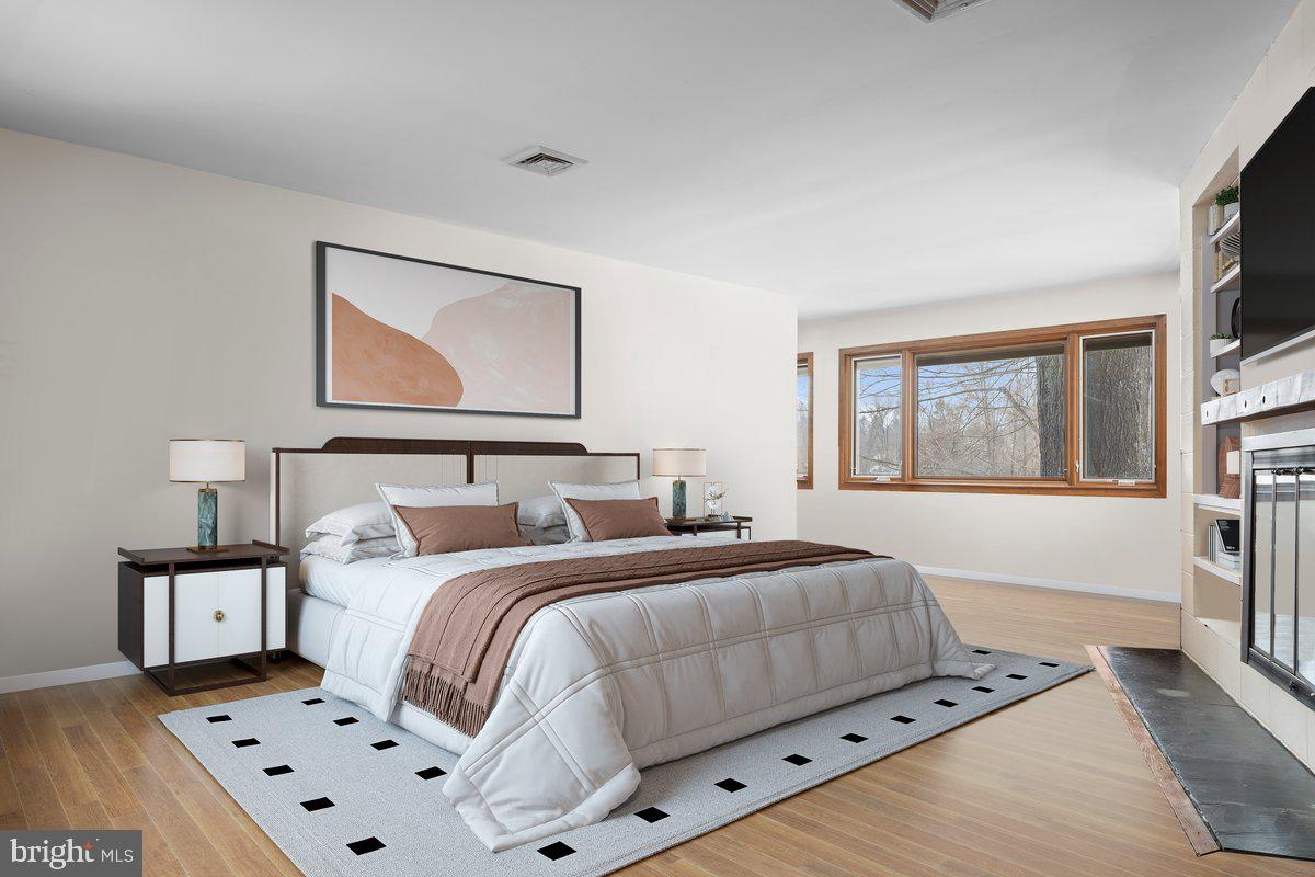 1112 General Saint Claire Road Washington Crossing, PA 18977 - Photo 16 of 34 a bedroom with a bed and a flat screen tv