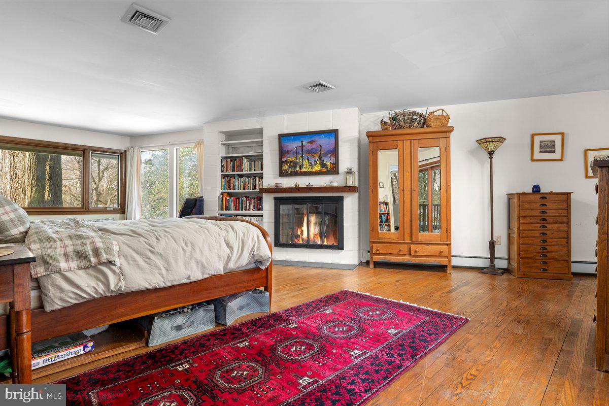 1112 General Saint Claire Road Washington Crossing, PA 18977 - Photo 19 of 34 a bedroom with bed and a fireplace