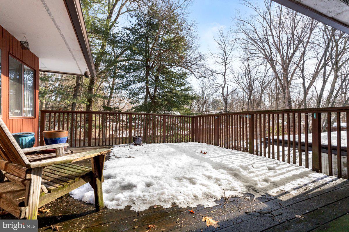 1112 General Saint Claire Road Washington Crossing, PA 18977 - Photo 20 of 34 a view of a wooden deck with two chairs and a table