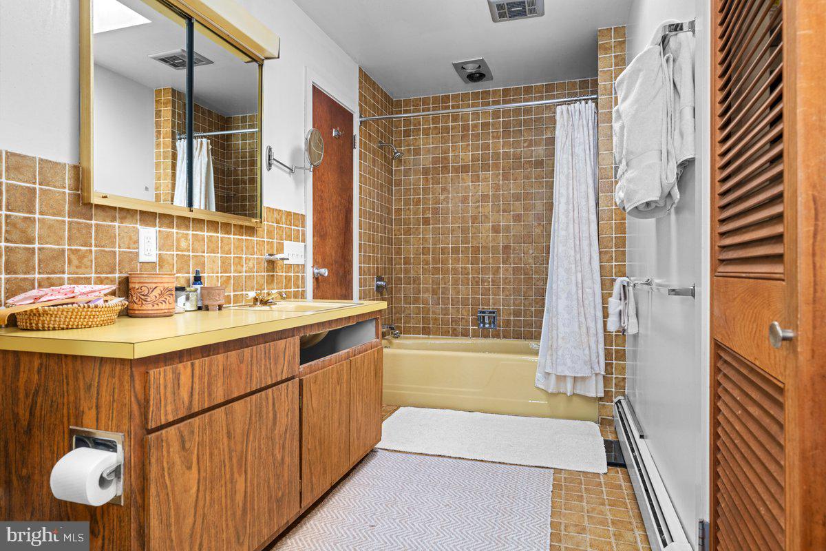 1112 General Saint Claire Road Washington Crossing, PA 18977 - Photo 22 of 34 a bathroom with a sink a mirror and a shower