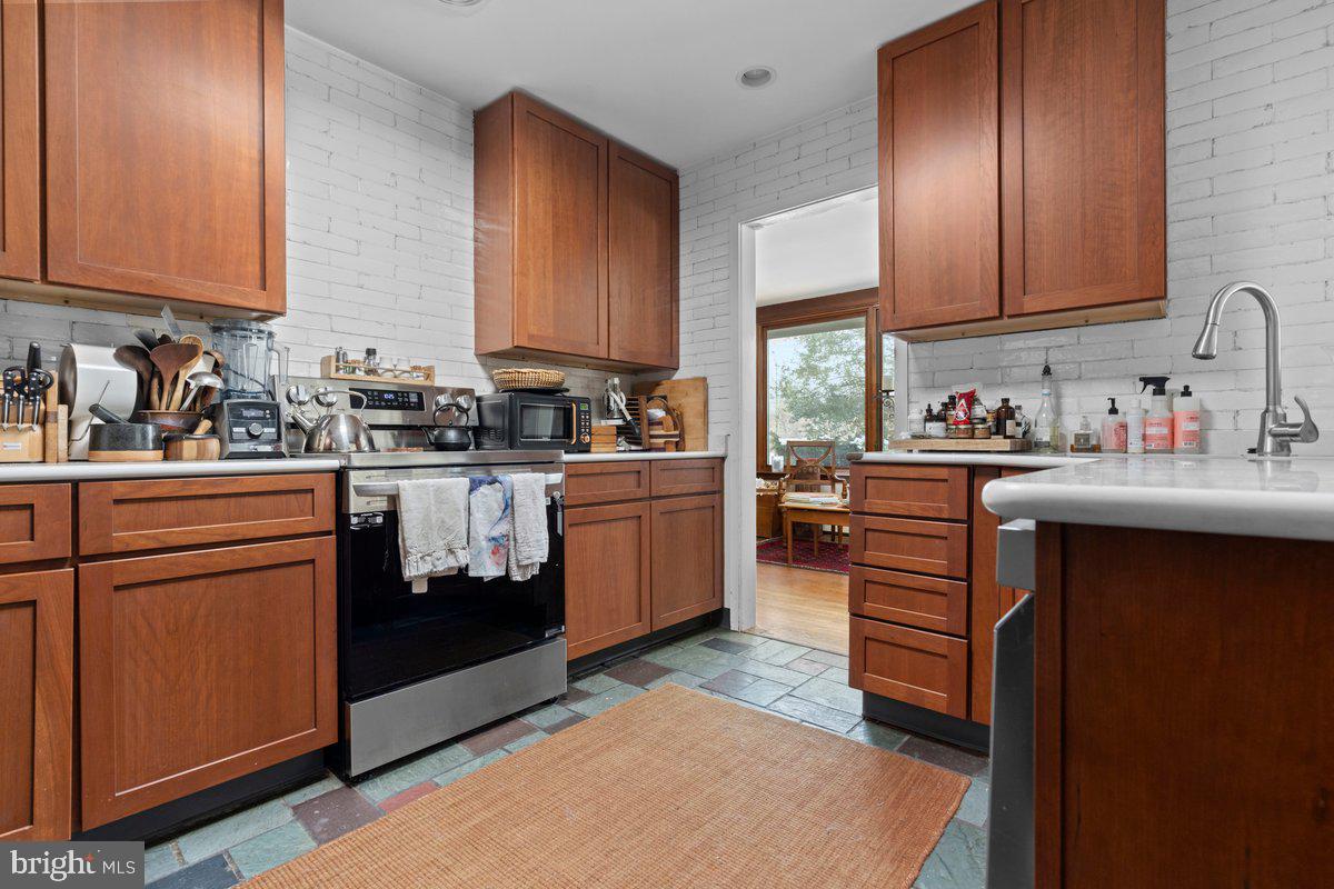 1112 General Saint Claire Road Washington Crossing, PA 18977 - Photo 9 of 34 a kitchen with a sink stove and cabinets
