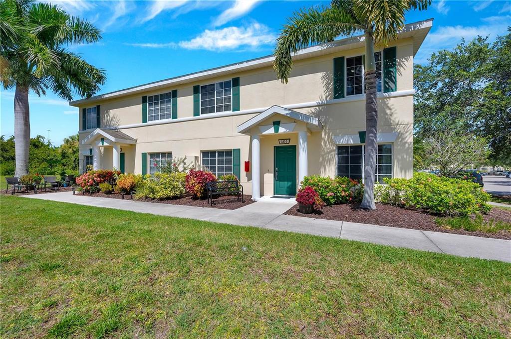 280 Cape Harbour Loop, Unit 101 Bradenton, FL 34212 - Photo 1 of 35 a front view of a house with porch and garden