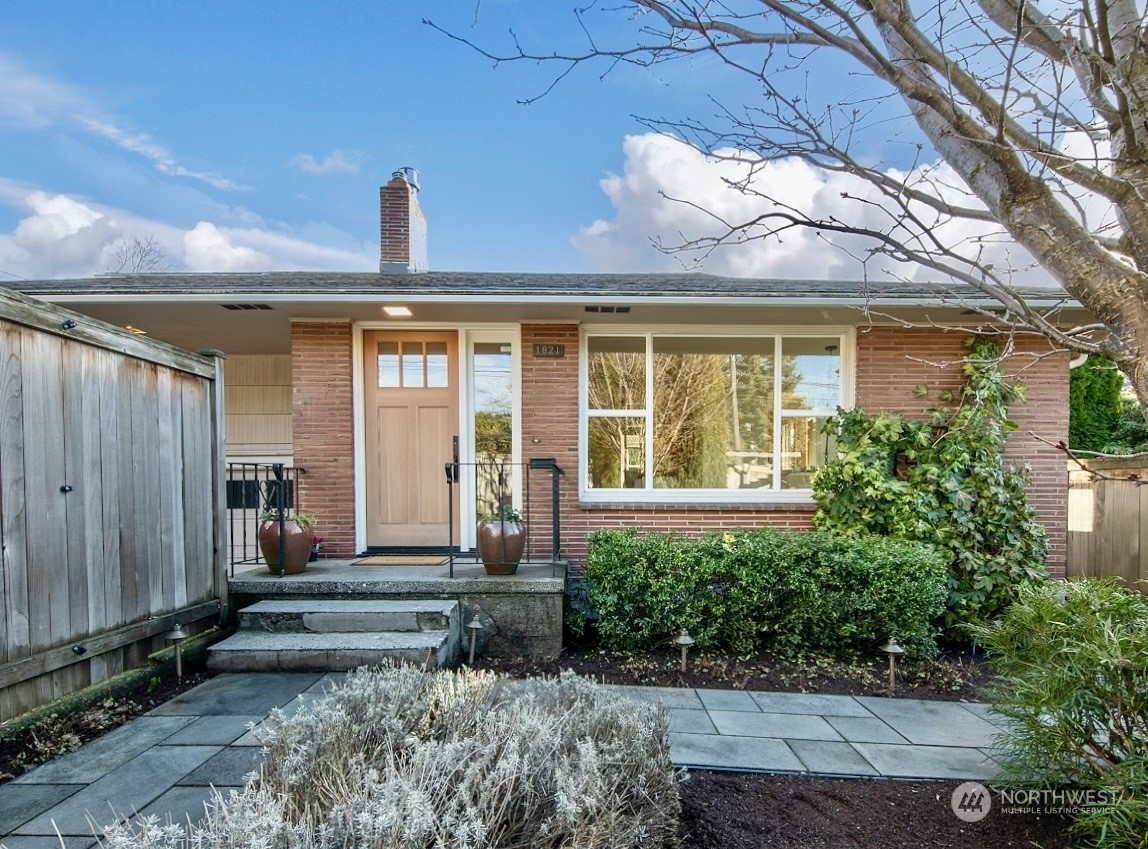 1821 North 80th Street Seattle, WA 98103 - Photo 1 of 30 a front view of a house with garden