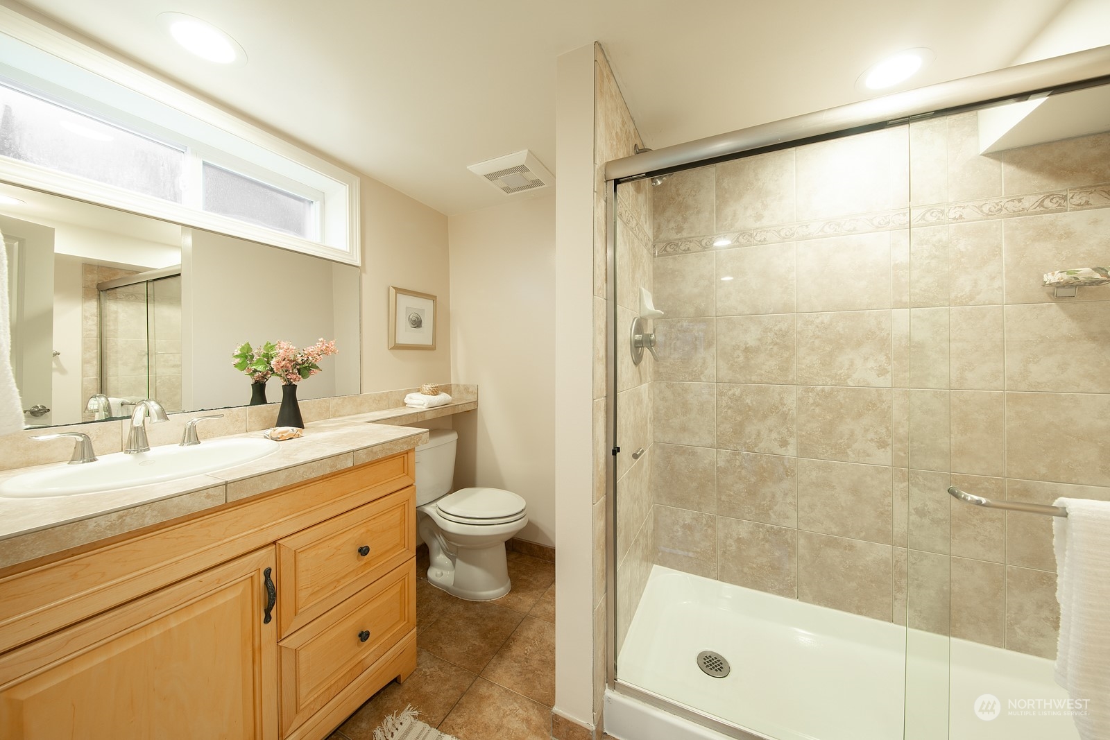 1821 North 80th Street Seattle, WA 98103 - Photo 16 of 30 a bathroom with a shower sink vanity mirror and toilet