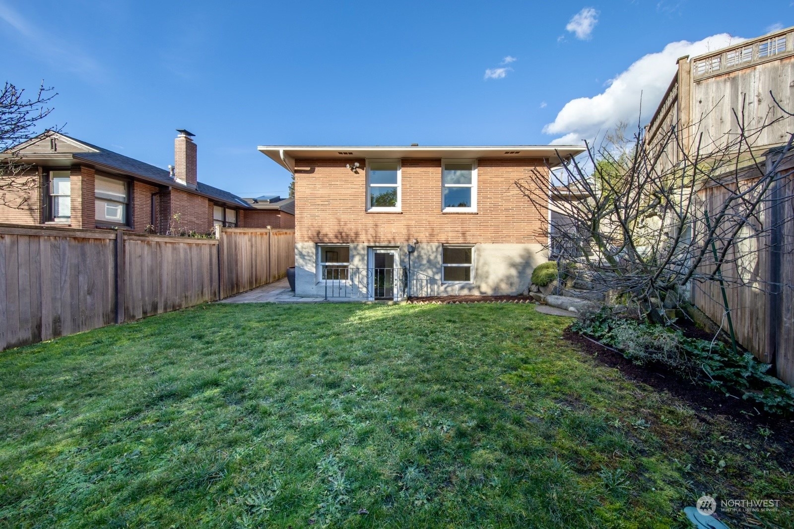 1821 North 80th Street Seattle, WA 98103 - Photo 21 of 30 a backyard of a house with lots of green space