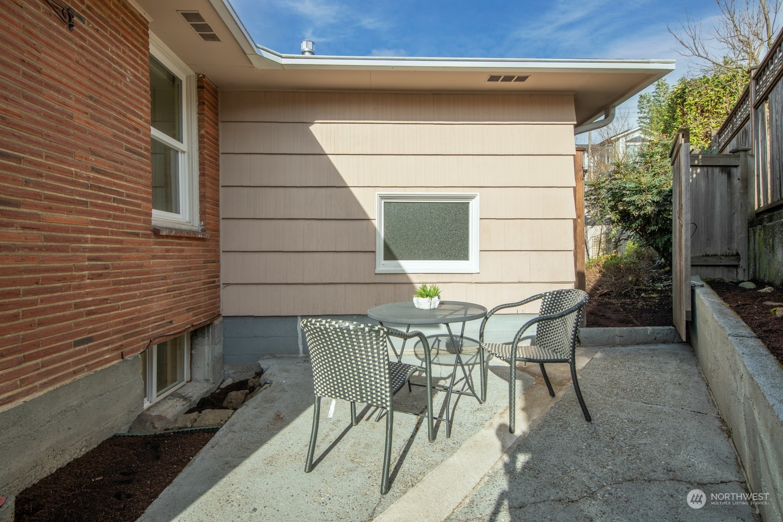 1821 North 80th Street Seattle, WA 98103 - Photo 22 of 30 a view of a patio with table and chairs and potted plants