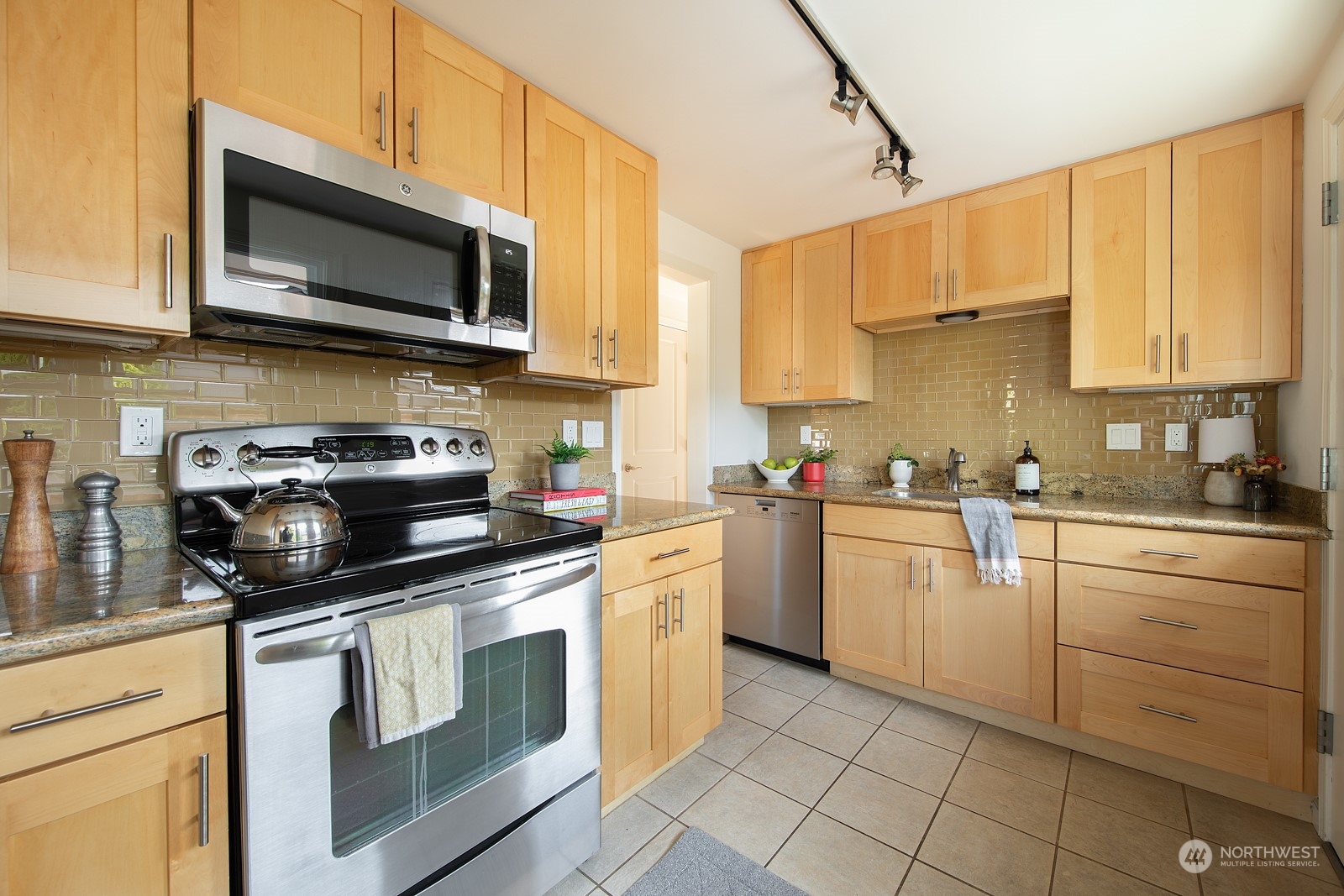 1821 North 80th Street Seattle, WA 98103 - Photo 6 of 30 a kitchen with a stove top oven sink and cabinets