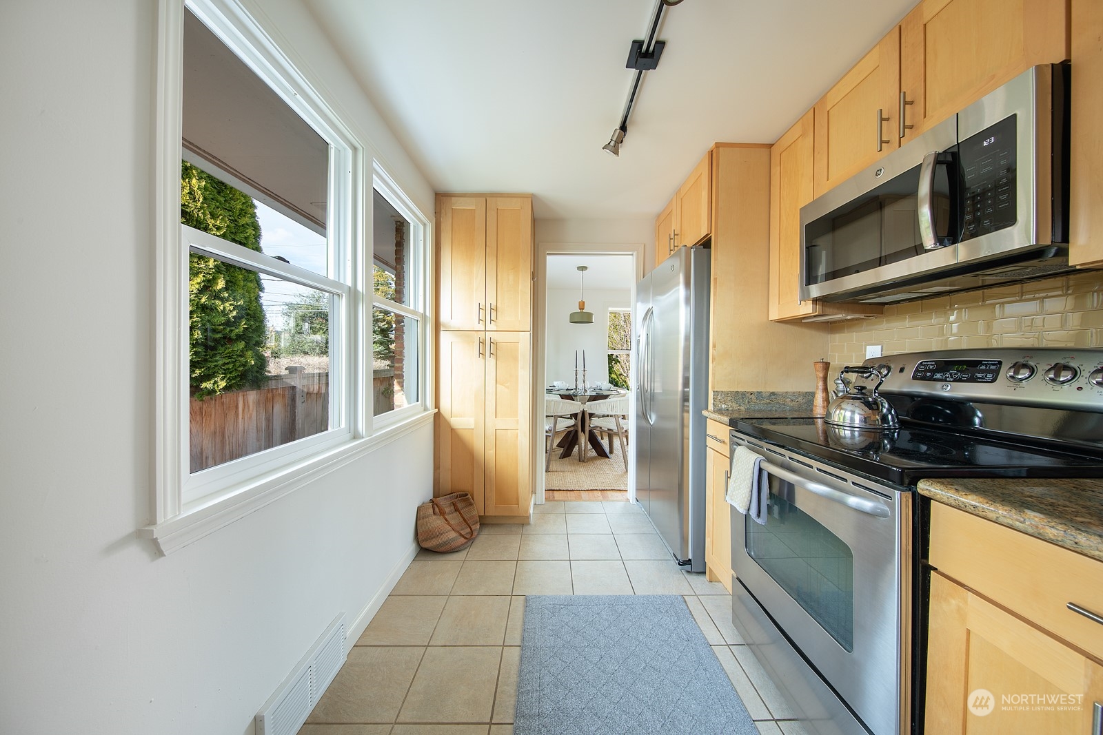 1821 North 80th Street Seattle, WA 98103 - Photo 7 of 30 a kitchen with stainless steel appliances granite countertop a refrigerator a stove top oven a sink and dishwasher