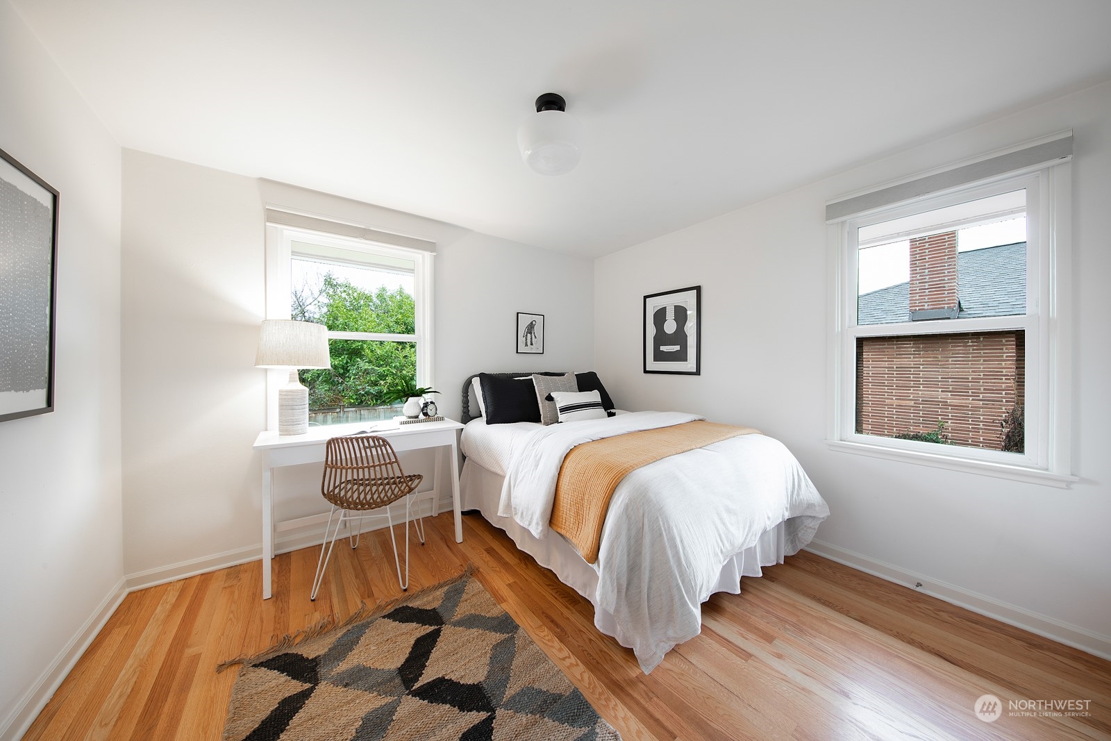 1821 North 80th Street Seattle, WA 98103 - Photo 8 of 30 a bed sitting in a bedroom next to a window